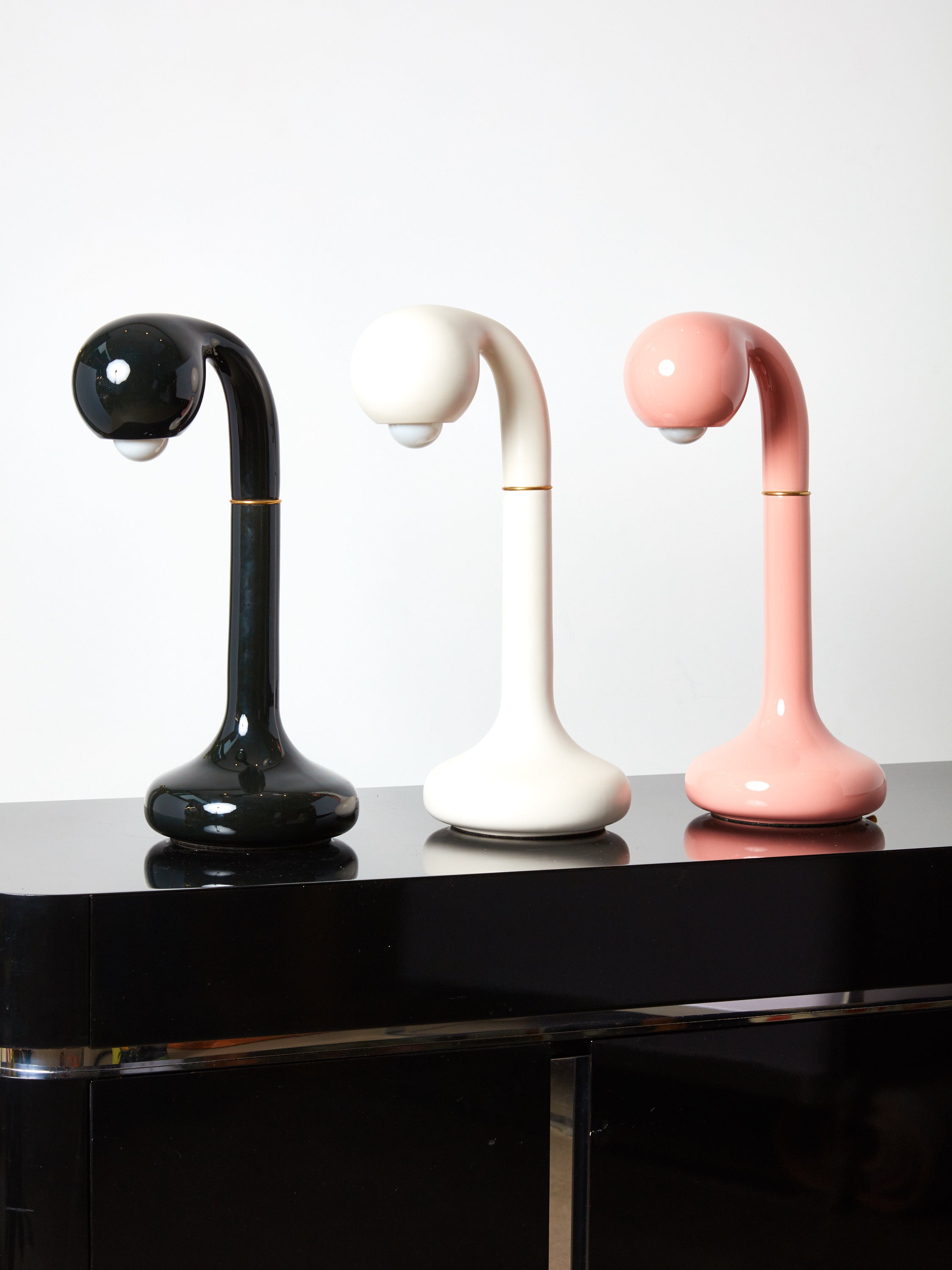 Black, white, and pink ceramic table lamps by Entler Studio in a row.