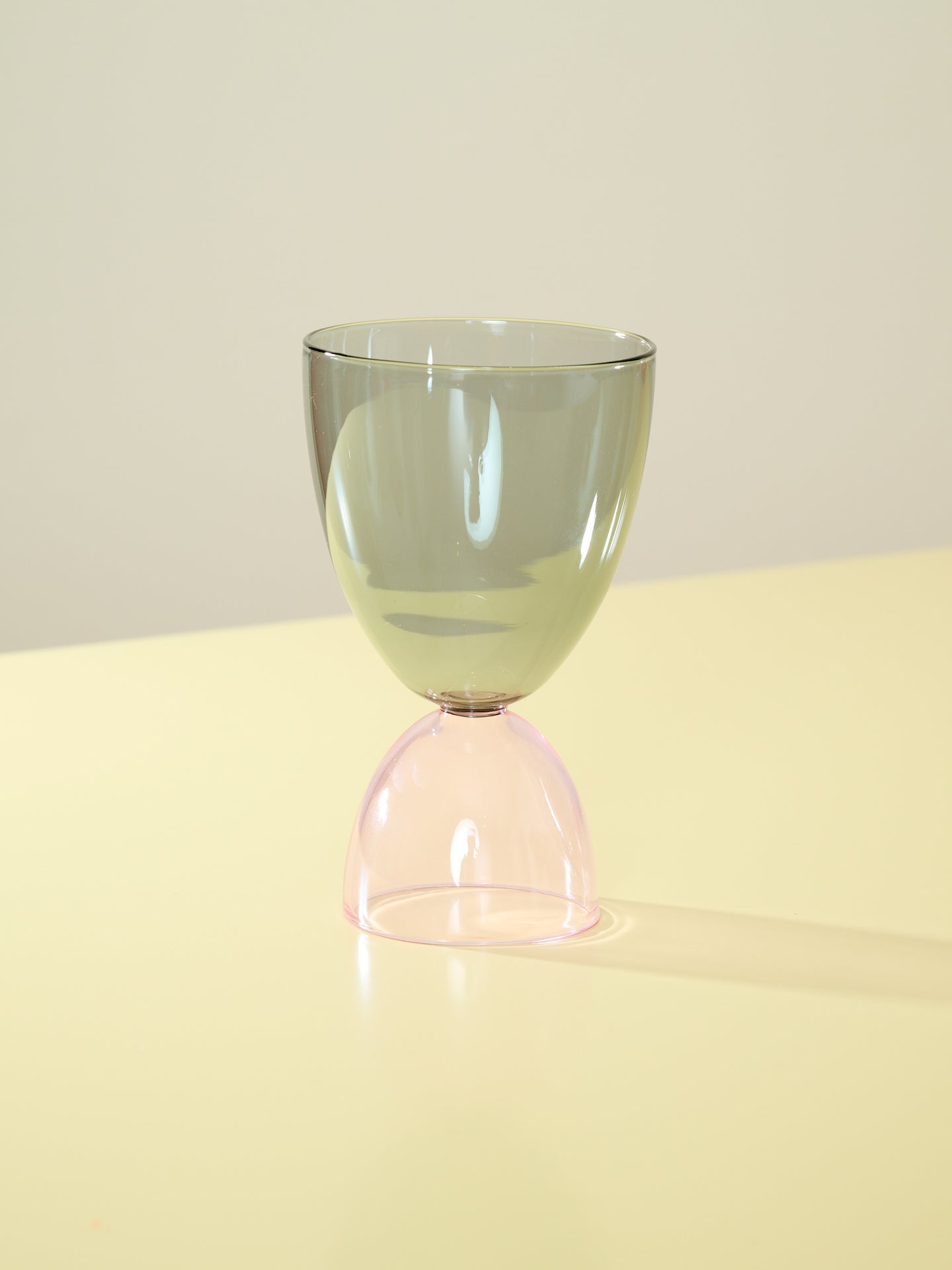 A smoke top and pink bottom cocktail glass.
