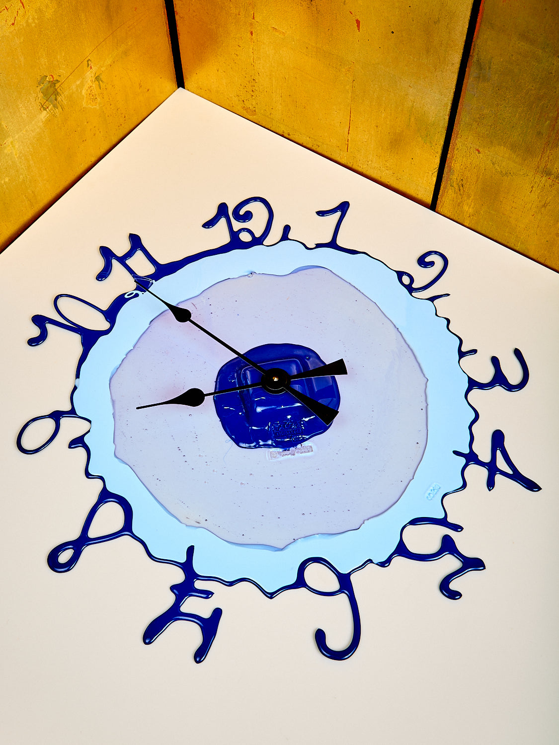 A vibrant hand-made resin wall clock with shades of blue, designed by Gaetano Pesce for Fish Design.