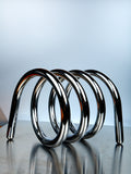 Metallic spiral design on a reflective surface with a gradient background