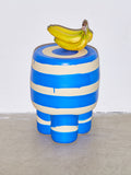 A bunch of bananas sits atop a blue Ceramic Milking Stool by Workaday Handmade.